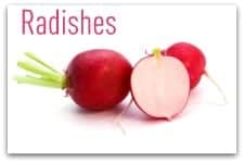 whole and half radishes close-up isolated on white