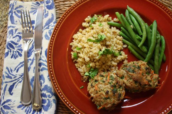 Paleo Potsticker Meatballs 4 Meatballs served with green beans and cauliflower rice on red plate with utensils