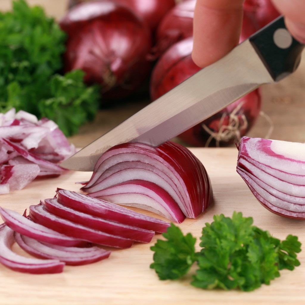 Preparing food: cutting a red onion